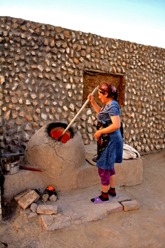 Kazakh Woman Stoking the Tandyr